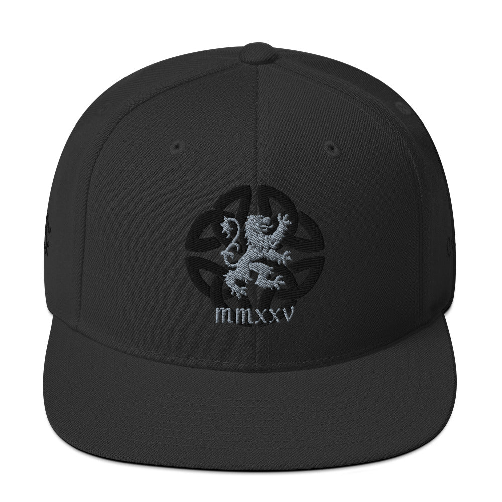 black snapback hat with subtle Celtic knot background and silver lion crest embroidery, Agilis Cultus MMXXV branding