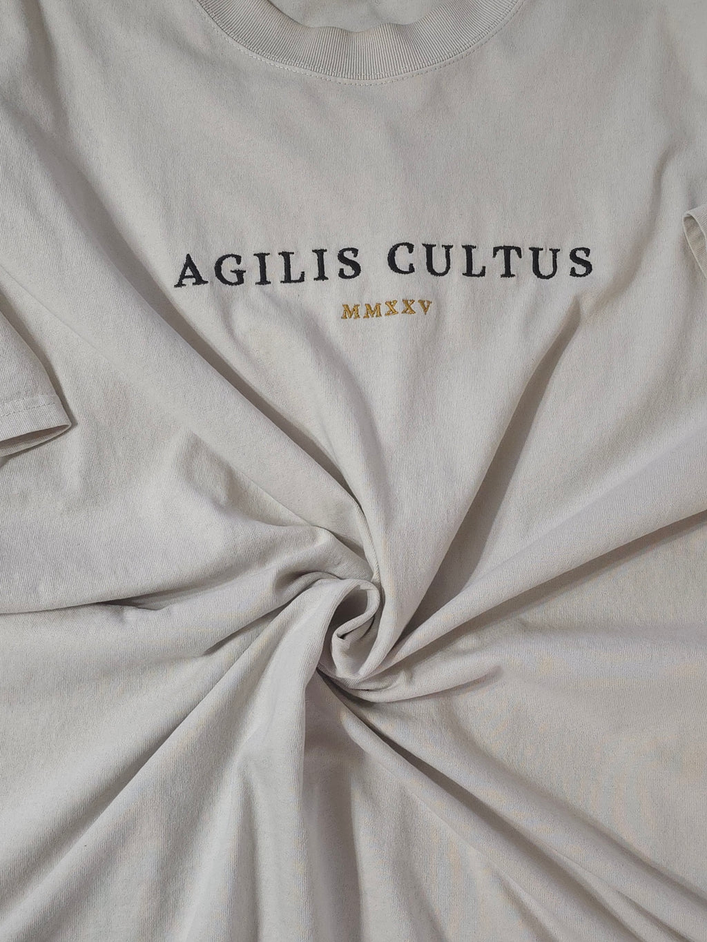 Close-up of bone fabric with 'AGILIS CULTUS' text on a bone background