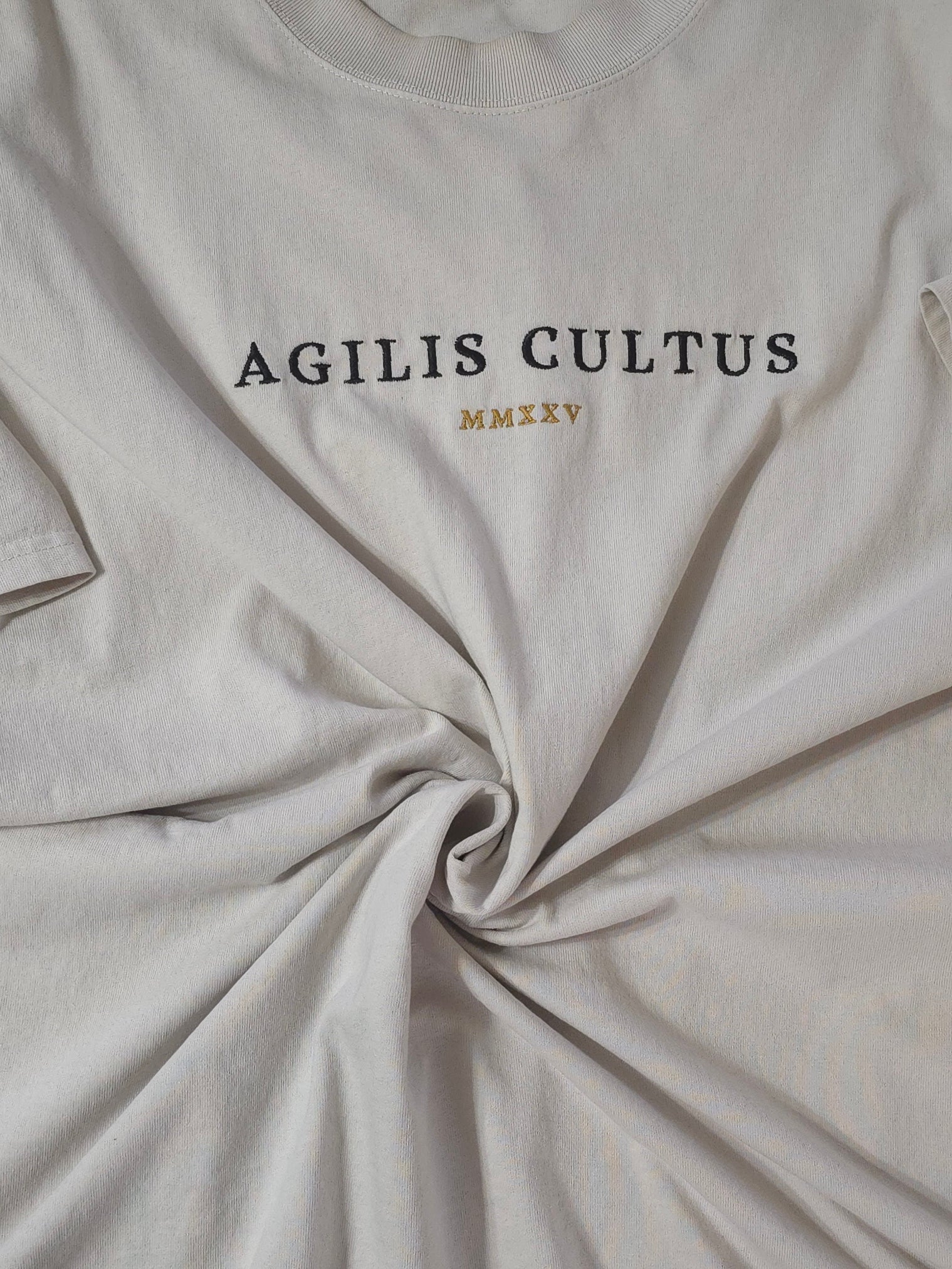 Close-up of bone fabric with 'AGILIS CULTUS' text on a bone background