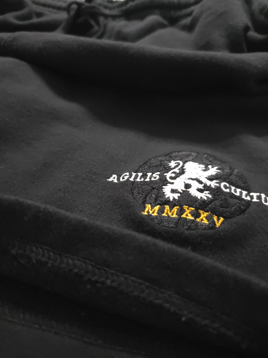 black heavyweight fleece with embroidered detail and hem stitching