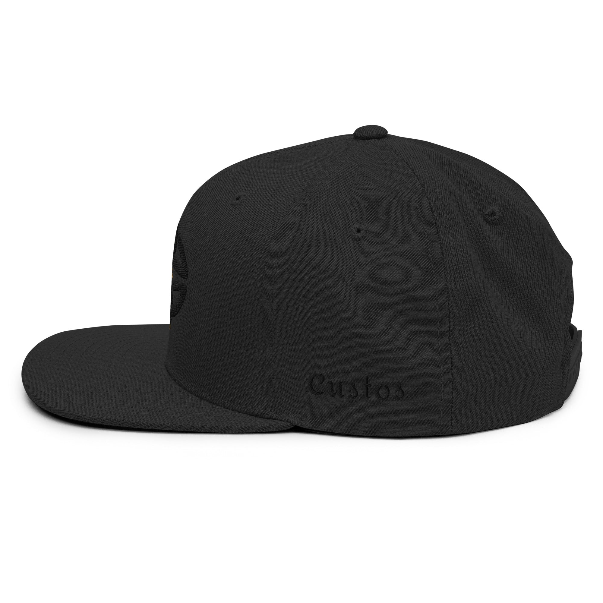 Black and gold cap with a logo on a white background left side view