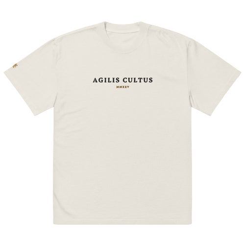 AC Heavyweight Oversized Tee in faded bone — garment dyed 100% carded cotton, boxy fit with dropped shoulders and embroidered Celtic crest, by Agilis Cultus